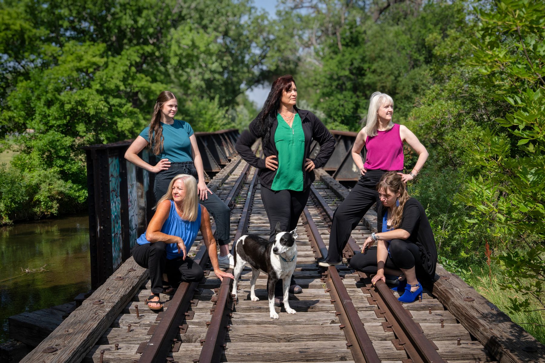 The Solutions team and the clinic dog on a railroad bridge